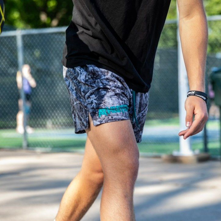 Player dribbling a basketball in Athletes of God shorts