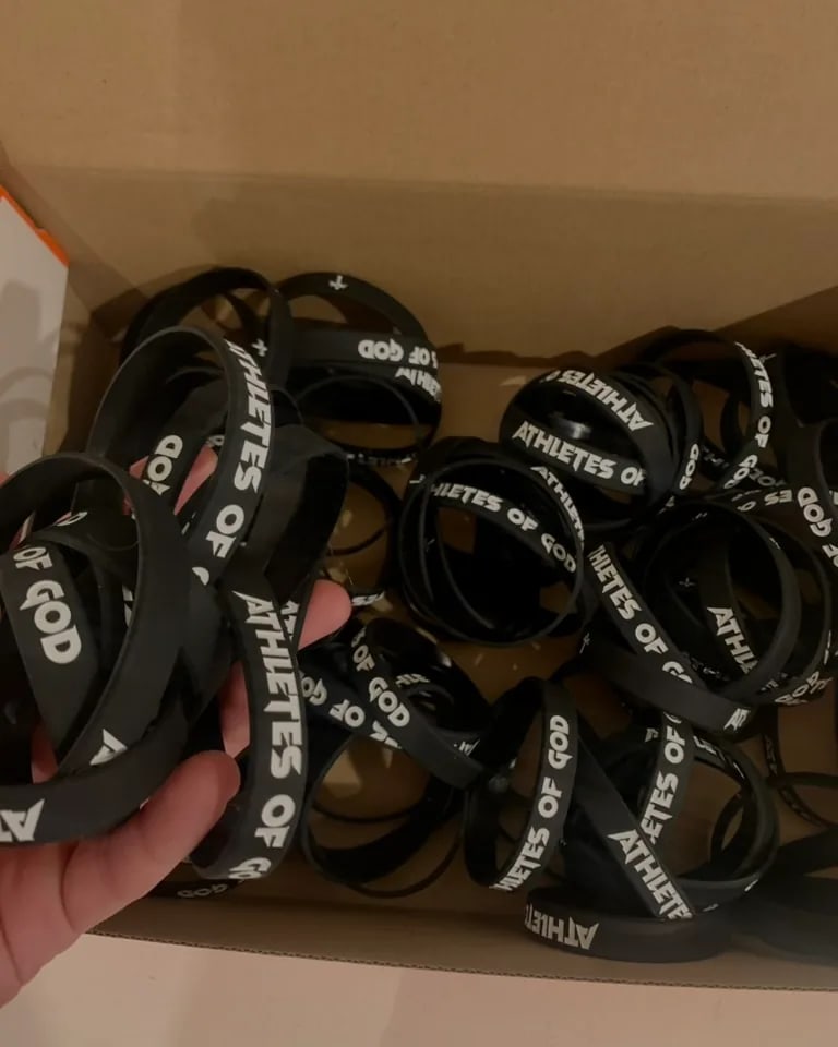 A box full of black Athletes of God silicone wristbands